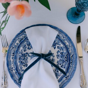 Blue, bow napkin rings in a Christmas table setting of blue Tonkin plates.