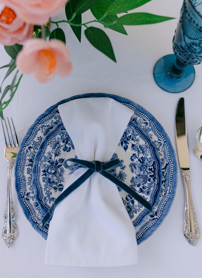 Blue, bow napkin rings in a Christmas table setting of blue Tonkin plates.