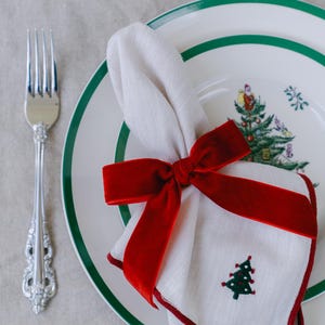 Classic red, bow napkin rings in a Christmas table setting.