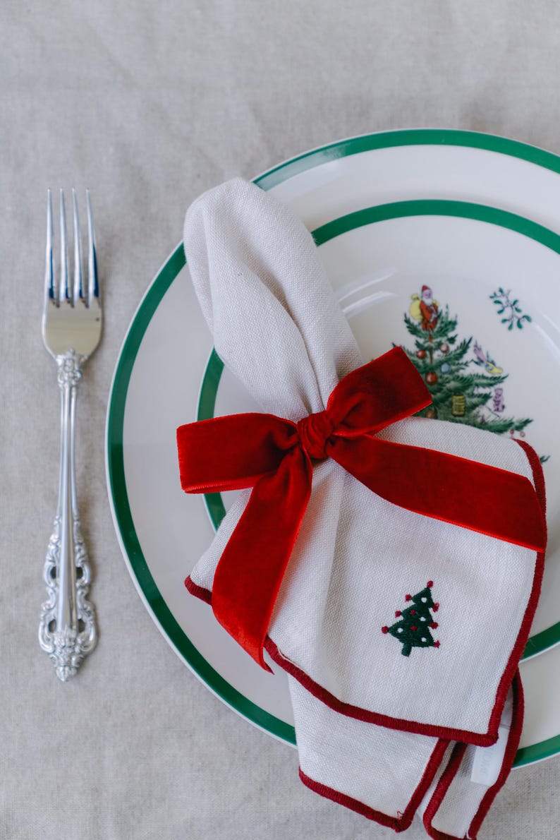 Classic red, bow napkin rings in a Christmas table setting.