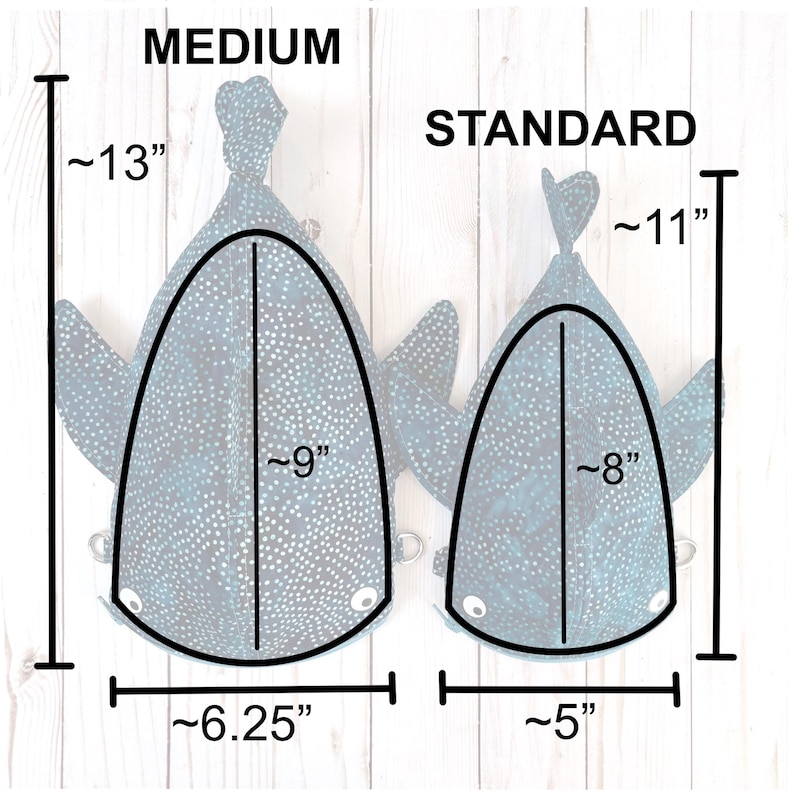 May include: Two fabric whale shark-shaped bags, one labeled "MEDIUM" and the other "STANDARD." The medium bag is approximately 33 cm tall, 23 cm wide, and 16 cm across. The standard bag is approximately 28 cm tall, 20 cm wide, and 13 cm across.