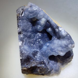 Purple and blue botryoidal chalcedony. in matrix