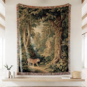 May include: A woven tapestry featuring a detailed forest scene with a tiger. The artwork showcases a lush landscape with trees, foliage, and a pathway. The tapestry has a fringed edge and is displayed on a wall.