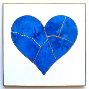 May include: A blue heart with gold cracks painted on a white background.
