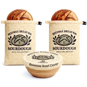 May include: Two beige beeswax bread bags with sourdough bread inside, and a beeswax bowl cover. The bags have the text "BEESWAX BREAD BAG" and "SOURDOUGH". The bowl cover is on a wooden bowl.