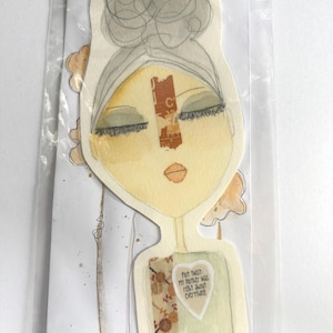 May include: An affirmation art card in a clear plastic sleeve. The card features a watercolor illustration of a woman's face with closed eyes, a neutral color palette, and the text "Plot Twist: My mother was right about everything."