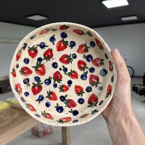 Handmade ceramic bowl with strawberry and blueberry fruit pattern
