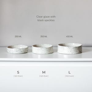 May include: Three ceramic bowls with a clear glaze and black speckles, arranged by size. The small bowl is 250 ml, the medium is 350 ml, and the large is 450 ml. The small and medium bowls are 12.5-13 cm, and the large bowl is 13.5-14 cm.