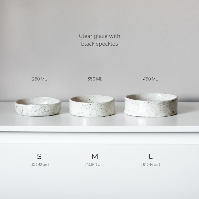 May include: Three ceramic bowls with a clear glaze and black speckles, arranged by size. The small bowl is 250 ml, the medium is 350 ml, and the large is 450 ml. The small and medium bowls are 12.5-13 cm, and the large bowl is 13.5-14 cm.
