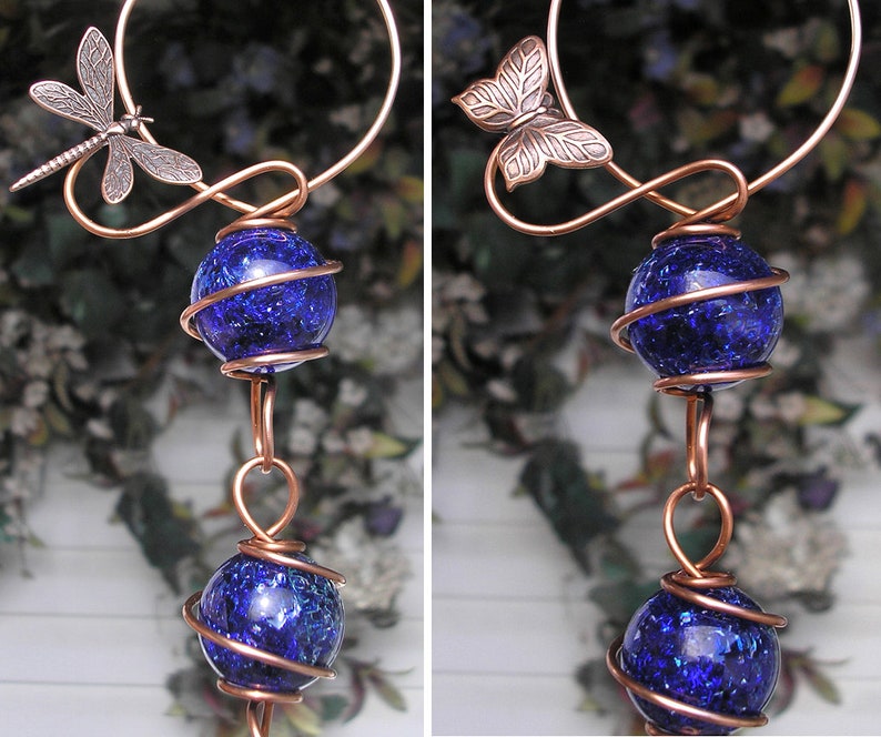 May include: Copper wire wind chime with two blue glass orbs and a dragonfly at the top.