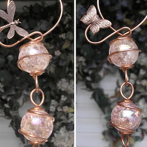 May include: Copper wire wind chime with two iridescent glass orbs and a dragonfly and butterfly charm.