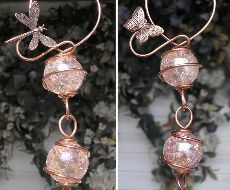 May include: Copper wire wind chime with two iridescent glass orbs and a dragonfly and butterfly charm.
