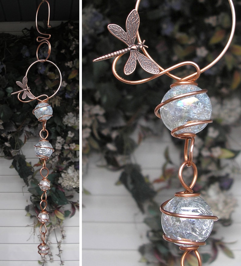 May include: A copper wire wind chime with a dragonfly design and clear glass orbs. The orbs are wrapped in copper wire and hang from a chain.