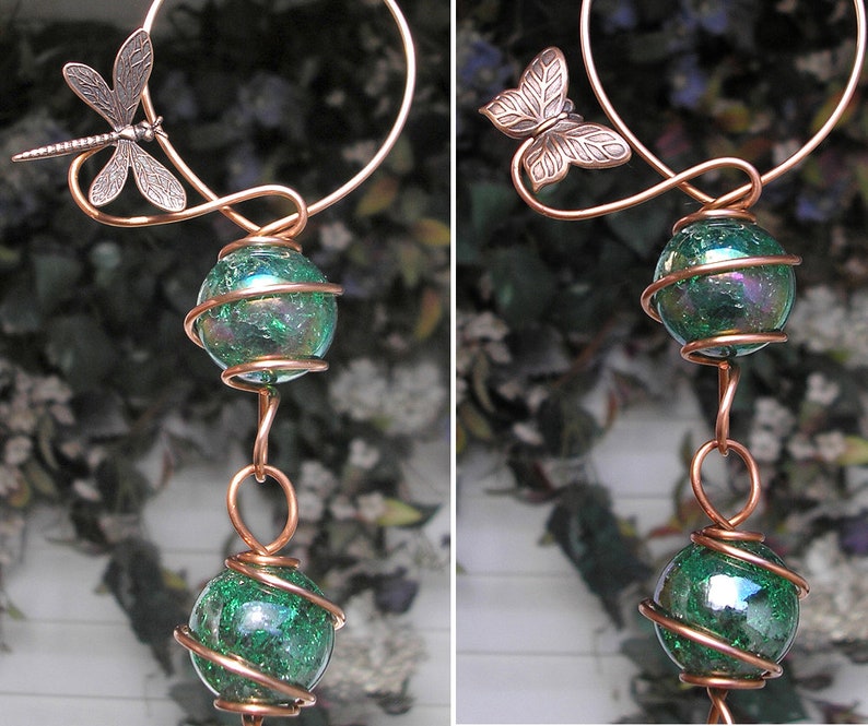May include: A copper wire wind chime with two green iridescent glass balls and a dragonfly and butterfly charm.