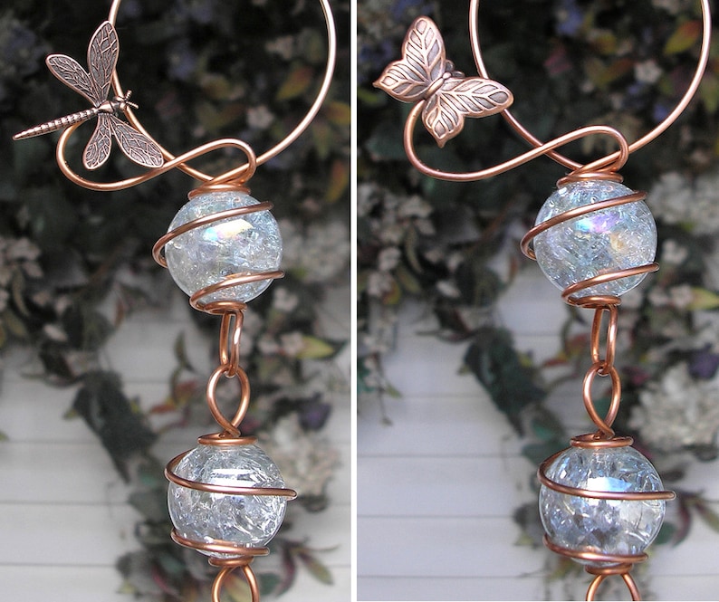 May include: Copper wire wind chime with two clear glass orbs wrapped in copper wire and a dragonfly and butterfly design.