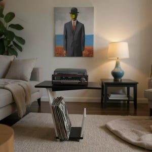 May include: A black and white side table with a flat top surface and a lower storage compartment containing a collection of vinyl records. A dark red and black record player sits on the top surface of the table, which is positioned in a room.