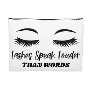 Könnte beinhalten: Weiße Kosmetiktasche mit schwarzem Reißverschluss und goldfarbenem Zipper. Die Tasche zeigt ein Design geschlossener Augen mit langen Wimpern über dem Text "Lashes Speak Louder Than Words" in Schwarz.