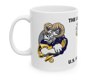 May include: White ceramic mug featuring a cartoon ram in a navy uniform, holding a gold anchor. The mug has the text "THE GO" and "U.S. NAVY" printed on it. The ram has a stern expression.