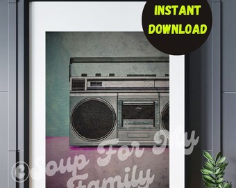 May include: A vintage silver boombox with a cassette player and radio tuner. The boombox is sitting on a pink and purple surface with the text "Soup For My Family" printed on it.