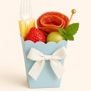 May include: A light blue container with a white bow, filled with a strawberry, green grape, salami, cheese, and mint. A clear plastic fork and a gold-topped toothpick are also included. The container has a scalloped edge.
