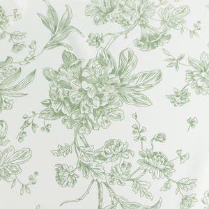 May include: A white background with a repeating pattern of green floral illustrations. The design features detailed drawings of various flowers, leaves, and stems, creating a classic, botanical aesthetic. The overall look is delicate and elegant.