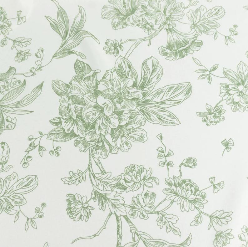 May include: A white background with a repeating pattern of green floral illustrations. The design features detailed drawings of various flowers, leaves, and stems, creating a classic, botanical aesthetic. The overall look is delicate and elegant.