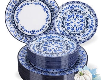 May include: A collection of blue and white decorative plates with intricate floral and geometric patterns. The plates are stacked and arranged, showcasing the design. A small white pumpkin and blue leaves are in the foreground, suggesting a fall theme.