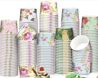 May include: A collection of floral-patterned paper cups in various colors, including pink, yellow, blue, and green. The cups feature rose designs and are stacked in neat piles, suggesting a party or event setting. Some cups are open, revealing their white interiors.