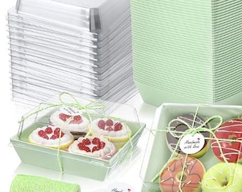 May include: A collection of bakery boxes with clear lids, stacked and filled with treats. The boxes are light green and tied with green twine. The treats include cupcakes and donuts, with "Handmade with love" tags.