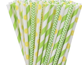 May include: A collection of paper straws with diverse patterns. Some have diagonal green stripes, others a zigzag design, and some feature yellow lemon slices. The straws are white and green, ideal for a summer gathering.