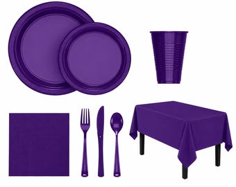 May include: A collection of purple party supplies, including plates, a cup, cutlery, a napkin, and a rectangular tablecloth. The plates have a decorative edge. The cup has vertical ridges. The tablecloth is on a black table.