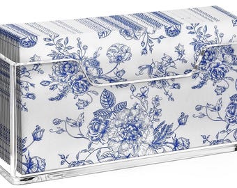 May include: A clear acrylic napkin holder with a rectangular shape, holding a stack of white napkins. The napkins feature a blue floral design. The holder has a simple, modern design, suitable for home decor.