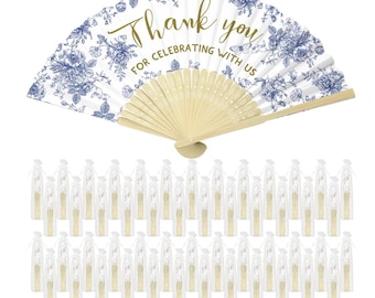 May include: A selection of wedding fans. The large fan features a blue floral pattern on a white backdrop, with gold text reading "Thank you for celebrating with us". Smaller fans are individually wrapped.