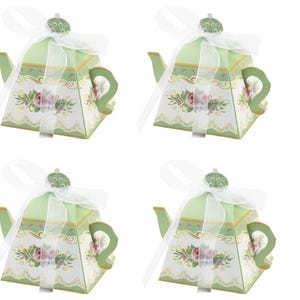 May include: A set of three ceramic mugs with a speckled, matte finish. Each mug features a different color: light blue, cream, and gray. The mugs have a simple, modern design with a rounded shape and a handle.