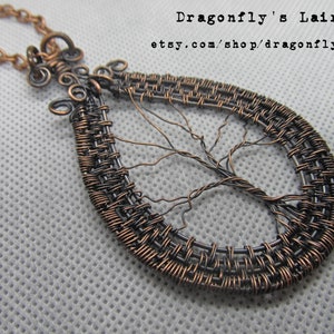 May include: A copper wire tree of life pendant necklace. The pendant is shaped like a teardrop and features a delicate wire tree design. The necklace is made of copper wire and has a simple chain.