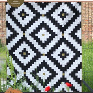 May include: A black and white quilt with a geometric diamond pattern. The quilt has a repeating design of black blocks on a white background, with small gold squares at the center of some diamonds. The text "BAZAAR DIAMONDS quilt pattern" is at the top.