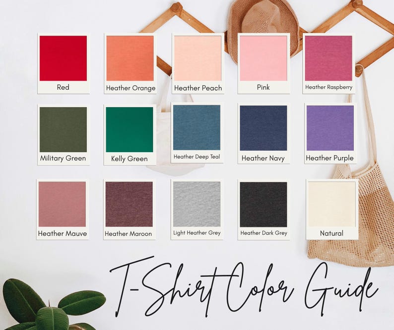 a color guide for t-shirt colors, featuring twelve different color swatches arranged in a grid. The swatches include various shades of red, orange, peach, pink, raspberry, navy, purple, green, teal, navy blue, gray, maroon, light grey, dark grey, and natural.