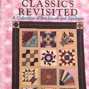 May include: A quilt with a brown frame and a beige background. The quilt is made up of 12 different squares, each with a different pattern. The patterns include a star, a flower, a fan, and a swirl. The quilt is titled "Classics Revisited: A Collection of Patchwork and Applique".