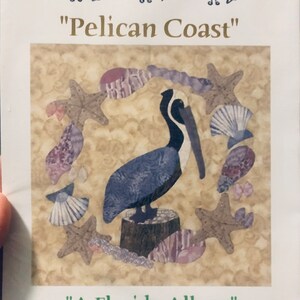 May include: A quilting pattern for a pelican with seashells and starfish. The pattern is called "A Florida Album" and is from the "Pelican Coast" collection. The pattern is 10 inches and the finished quilt is 51 inches by 51 inches.