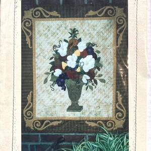 May include: A quilt pattern named "Hospitality Bouquet" showing a floral arrangement in a vase. The design includes white, red, and purple flowers, with green leaves and a pineapple. The dimensions are 94 cm wide by 114 cm long.