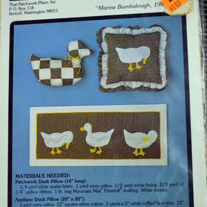 May include: A sewing pattern for making country-themed duck cushions and wall hangings. The pattern includes instructions for making a patchwork duck cushion, an applique duck cushion, and a wall hanging with three white ducks. The pattern is titled "Country Ducks" and is pattern number P-21. The pattern is by Marine Bumbalough and is on sale for £1.50.