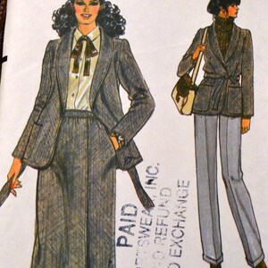 May include: Vintage Vogue Patterns sewing pattern featuring illustrations of women's suits. The pattern includes a skirt suit and a pantsuit, both with jackets. The text "Very Easy Vogue Patterns" is visible.