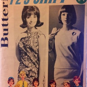 May include: A vintage sewing pattern for a dress with a 1-2-3-shift design. The pattern is from Butterick and is size 10, bust 31. The pattern features a dress with a floral print and a solid colour dress.