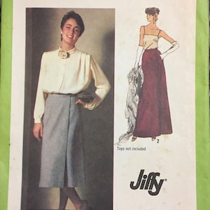May include: A sewing pattern for a skirt, Simplicity pattern number 9113, size 12, waist 26 1/2 inches. The pattern includes instructions for a skirt with a wrap-around design. The pattern is for misses. The image shows a model wearing a gray skirt with a white blouse. The text "Tops not included" is printed on the pattern.