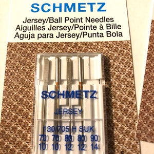 May include: A pack of 5 Schmetz Jersey/Ball Point needles for sewing. The needles are packaged in a clear plastic case with the brand name and size information printed on the front. The needles are designed for use with jersey fabrics.
