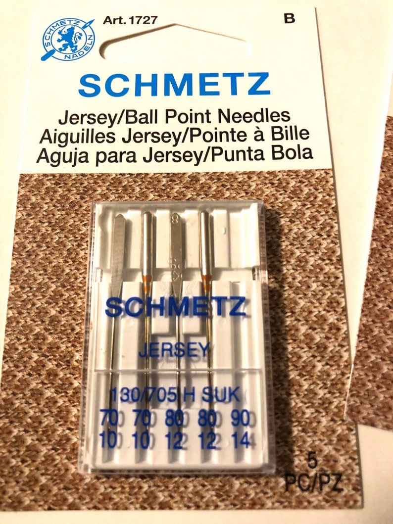 May include: A pack of 5 Schmetz Jersey/Ball Point needles for sewing. The needles are packaged in a clear plastic case with the brand name and size information printed on the front. The needles are designed for use with jersey fabrics.