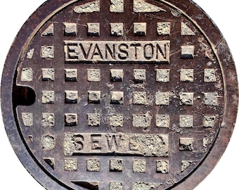 May include: A weathered, circular manhole cover with the text "EVANSTON" and "SEWER" embossed on it. The cover has a grid pattern of square indentations and a dark, rusty brown color.