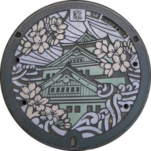 May include: A circular manhole cover with a detailed design featuring a Japanese castle, cherry blossoms, and waves. The cover is grey with white and green accents. The number "14" is visible on the cover.