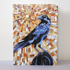 May include: A mosaic artwork depicting a blue crow perched on a rock. The background is a circular pattern of brown, orange, and white tiles.