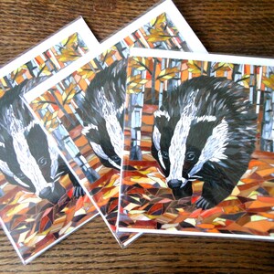 May include: Three cards with a mosaic illustration of a badger in an autumn forest. The badger is black and white with a white stripe down its face. The forest is made up of brown, orange, and yellow leaves.